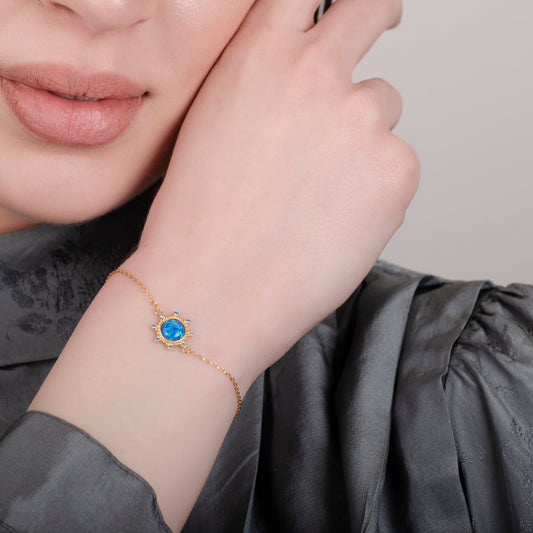 Armband aus 24 Karat Gold mit blauem Opal und Sternenlicht